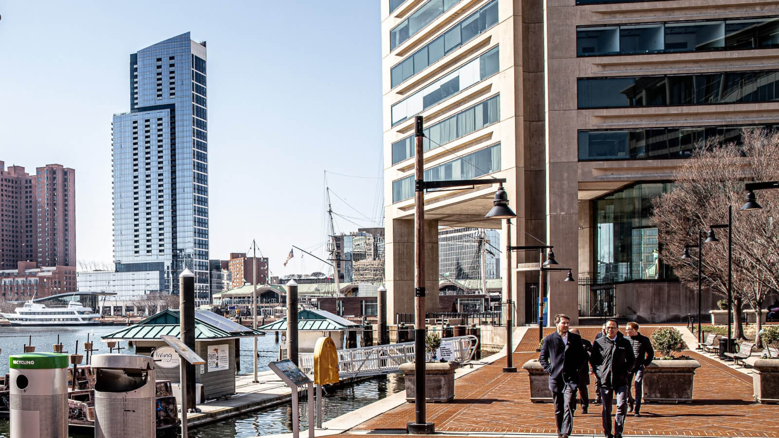 A photo of a small group of people walking on a sidewalk in Downtown Baltimore.